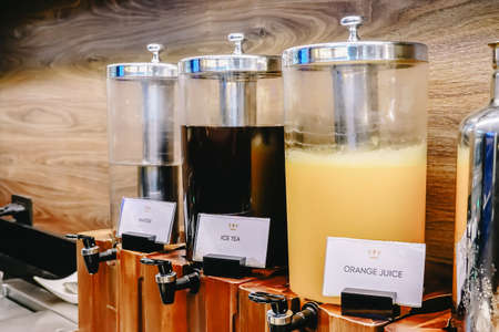 breakfast buffet line, various of beverages tank, orange juice, ice tea, water, in restaurantの写真素材