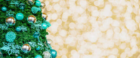 Decorated Christmas tree on Gold Christmas background of de-focused lightsの写真素材
