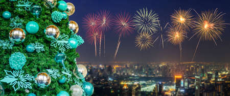 Decorated Christmas tree on New Year colorful fireworks with cityscape skyline in night time...