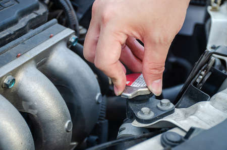 Man hand checking level of coolant car engine. Check and maintenance the coolant in car with yourself.の写真素材