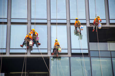 Bangkok, Thailand - Sep 25, 2019: Group of workers cleaning windows service on high rise building - High building and Risk working.のeditorial素材