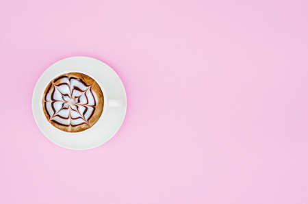 White cup of coffee on  pink pastel background. Copy spaceの写真素材