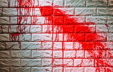 Background operators in Halloween festivities. Drop of red blood on a wall, Criminal and social issues conceptの写真素材