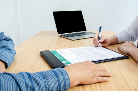 Female doctor hand hold silver pen filling patient history list at clipboard pad, Patient listening...