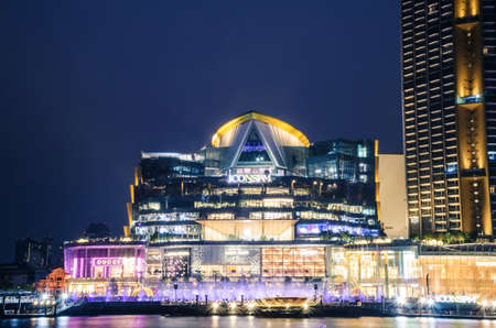 BANGKOK, THAILAND - 30 Jan, 2019: Exterior view of ICON Siam at River side. ICON SIAM is the new Shopping Center and Landmark of Bangkok at night with motion blur of many tourist in front.のeditorial素材