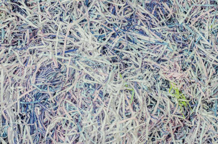 A tangled pile of paper cut into small pieces. Paper surface wallpaper background.の写真素材