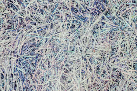 A tangled pile of paper cut into small pieces. Paper surface wallpaper background.の写真素材