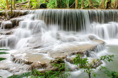 Travel to the beautiful waterfall in tropical rain forest, soft water of the stream in the natural park at Huai Mae Khamin Waterfall in Kanchanaburi, Thailand.の写真素材