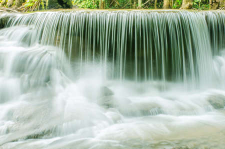 Travel to the beautiful waterfall in tropical rain forest, soft water of the stream in the natural...