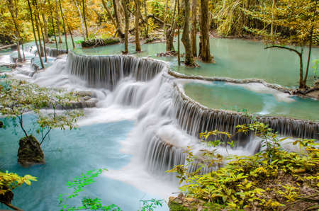 Travel to the beautiful waterfall in tropical rain forest, soft water of the stream in the natural park at Huai Mae Khamin Waterfall in Kanchanaburi, Thailand.の写真素材