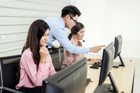 Customer service executive trainer assisting her team at office, Business Team Discussion Team Customer Service Conceptの写真素材