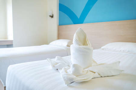 White towel on white bed decoration in bedroom interior of luxury boutique hotelの写真素材