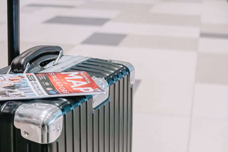 SINGAPORE - NOVEMBER  22, 2018: Traveling luggage in airport terminal with  tourist map , travel conceptのeditorial素材