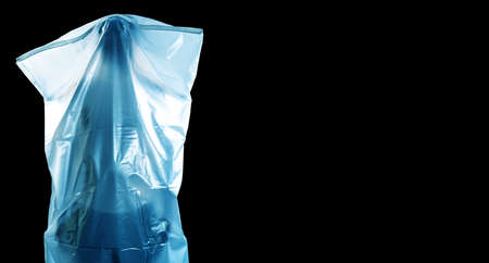 A man covered with a white shroud like a ghost shows horror isolated on black background with copy space, Halloween and horror, with clipping pathの写真素材