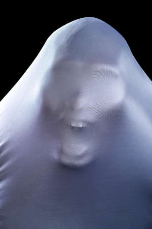 The man is in white clothes and shows a scary looking face  isolated on black background, look like ghost in night for Halloween Festival concept, clipping pathの写真素材