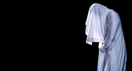 People are in white clothes and appear scary, look like ghost in night isolated on black background, Halloween Festival concept, Copy space ,with clipping pathの写真素材