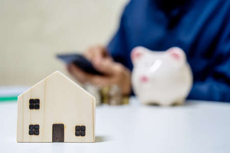 Business Real Estate Concept, Close up image of house model with business people working on blurred background, Concept investment mortgage finance and home loan business, business, innovation, growth and moneyの写真素材