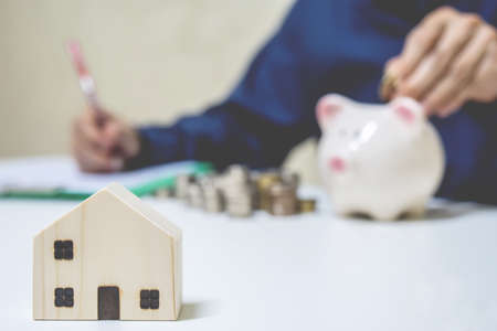 Business Real Estate Concept, Close up image of house model with business people working on blurred background, Concept investment mortgage finance and home loan business, business, innovation, growth and moneyの写真素材
