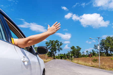 Happy man driver feeling the wind through his hands while driving in the countryside, freedom concept, copy spaceの写真素材