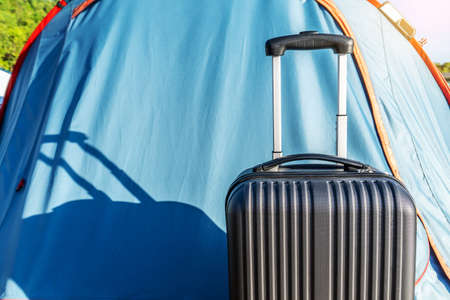 Travel suitcases in camping tent on countryside landscape background - Alternative summer holiday at national park - Road trip and freedom conceptの写真素材