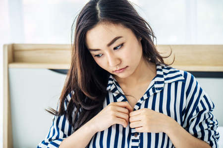 Images of young woman going to take off shirts By beginning to remove the buttons to begin pleasure, sex concept.の写真素材