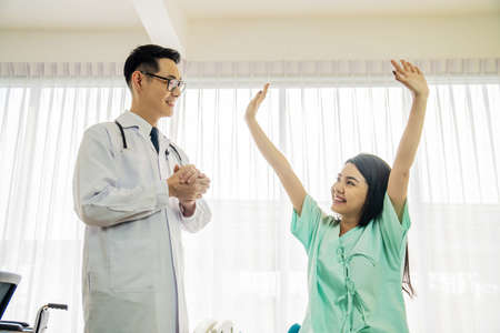 Happy woman patient after doctor told the good news to the patient at the doctor's office - medical and healthcare conceptの写真素材