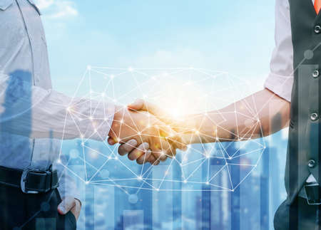 Business man handshake with effect global world map network link connection and graph chart of stock market graphic diagram, internet communication, stock market deal, Double exposureの写真素材