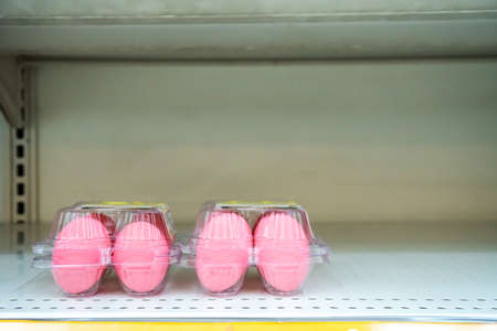 Empty egg shelves in a grocery store or supermarket after fear and panic shopping because of Covid-19, Hoarding food due to Coronavirus outbreak. Food shelf has been wiped out from panic buyingの写真素材