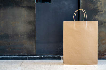 Contactless delivery, Office delivery of food grocery bag left at front door for Coronavirus spreading safety. Precautionary measures against COVID-19, paper bag delivered without contactの写真素材