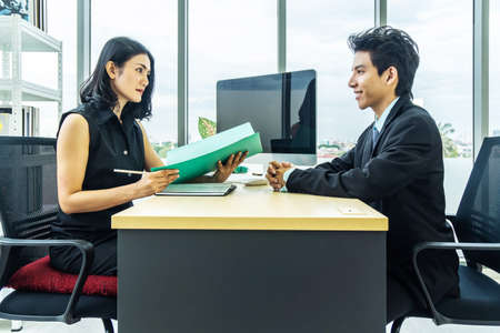 Job interview, Beautiful manager asian woman talking to a male job applicant at the desk, Businesswoman listen to candidate answers.の写真素材