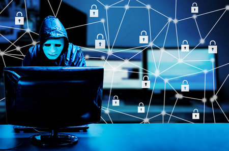 Anonymous computer hacker in white mask and hoodie standing in the middle and hacking it with his computer, Data theft, internet attack, Padlock Hologram icons over the computerの写真素材