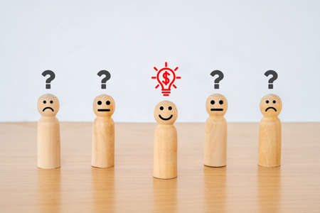 Concept creative idea in investment. smiley face on wood doll and light bulb with dollar symbol...
