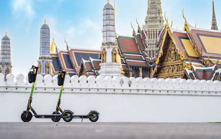 e-scooter parked in front of Wat Phra Kaew temple of the emerald buddha.の写真素材