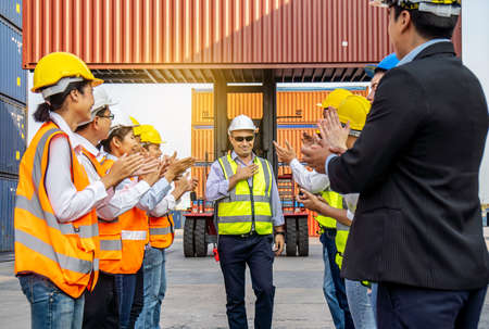 Professional Engineering and worker team congratulated success by applaud their jubilant leader after construction project complete with success. Engineering heavy industry conceptの写真素材