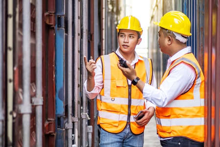 Professional of two engineer or supervisor checking and control loading Containers box from Cargo at harbor. Transportation and logistic conceptの写真素材