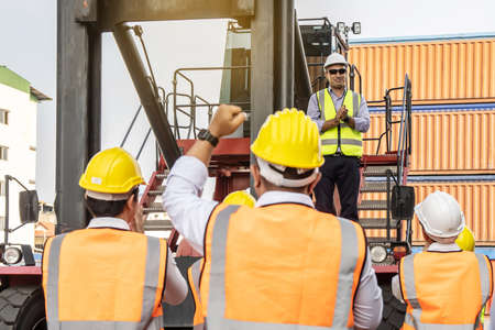 Professional Engineering and worker team congratulated success by applaud and raise one's hand to jubilant leader after construction project complete with success,Engineering heavy industry conceptの写真素材