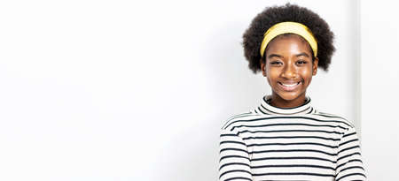 Cute african american girl with an afro hairstyle wearing casual clothes smiling, friendly welcome gestureの写真素材