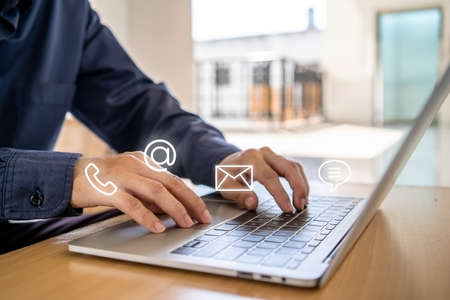 Hotline service, Customer support hotline Contact us people connection. Businessman using laptop with the email, call phone, address, Chat message iconsの写真素材