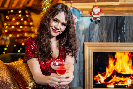 Young asian girl in red dress and red lip with cocktail in hands in club or bar, Beautiful woman enjoying alcoholic beverage cocktailの写真素材