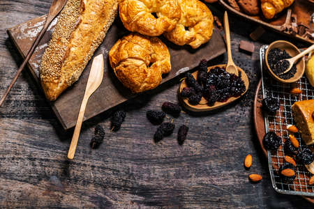 Top view of bread and loaf with cereals bread and bakery, breadsticks on wooden table in dark background with copy spaceの写真素材