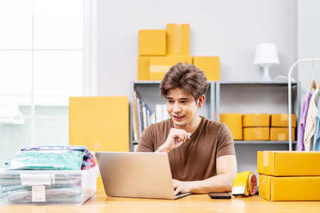 Entrepreneurs Small Business SME freelance working in home office using computer laptops for commercial checking, online marketing, packing boxes, SME sellers, concept, e-commerce team, online salesの写真素材