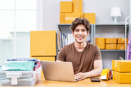Entrepreneurs Small Business SME freelance working in home office using computer laptops for commercial checking, online marketing, packing boxes, SME sellers, concept, e-commerce team, online salesの写真素材