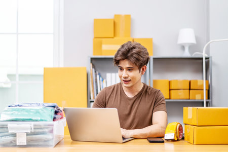 Entrepreneurs Small Business SME freelance working in home office using computer laptops for commercial checking, online marketing, packing boxes, SME sellers, concept, e-commerce team, online salesの写真素材