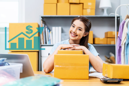 Portrait young attractive asia female owner startup business look at camera work happy with carton box at home prepare delivery to customers, procurement, omnichannel ecommerce online conceptの写真素材