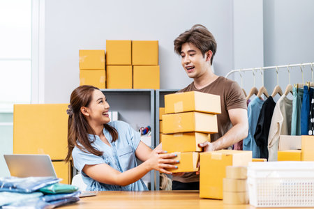 Young Asian couple business working in simple house office look like doing startup business and check store order by laptop, Surprise of couple success on making big sale of his online store.の写真素材