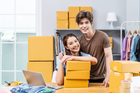 Young Asian couple business working in house office look like doing startup business and smiling happy and positive,Surprise of couple success on making big sale of his online store.の写真素材