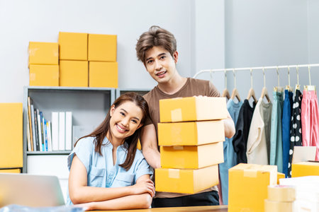 Young Asian couple business working in house office look like doing startup business and smiling happy and positive,Surprise of couple success on making big sale of his online store.の写真素材