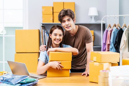 Young Asian couple business working in house office look like doing startup business and smiling happy and positive,Surprise of couple success on making big sale of his online store.の写真素材