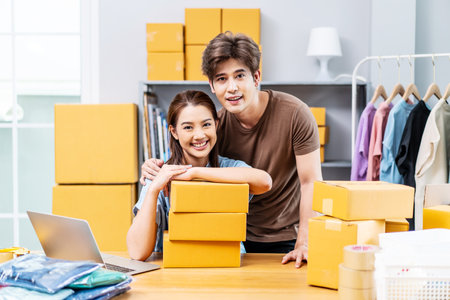 Young Asian couple business working in house office look like doing startup business and smiling happy and positive,Surprise of couple success on making big sale of his online store.の写真素材