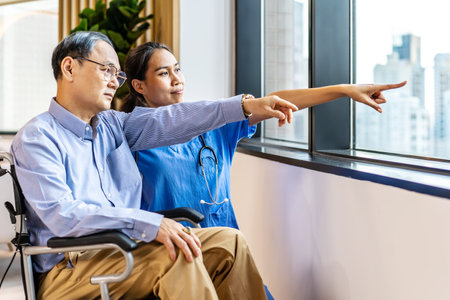 Asian female doctor or nurse treats elderly patient suffering from depression he was sitting in a wheelchair. The concept of senior patients, depressive disorders in the elderly. senior health careの写真素材